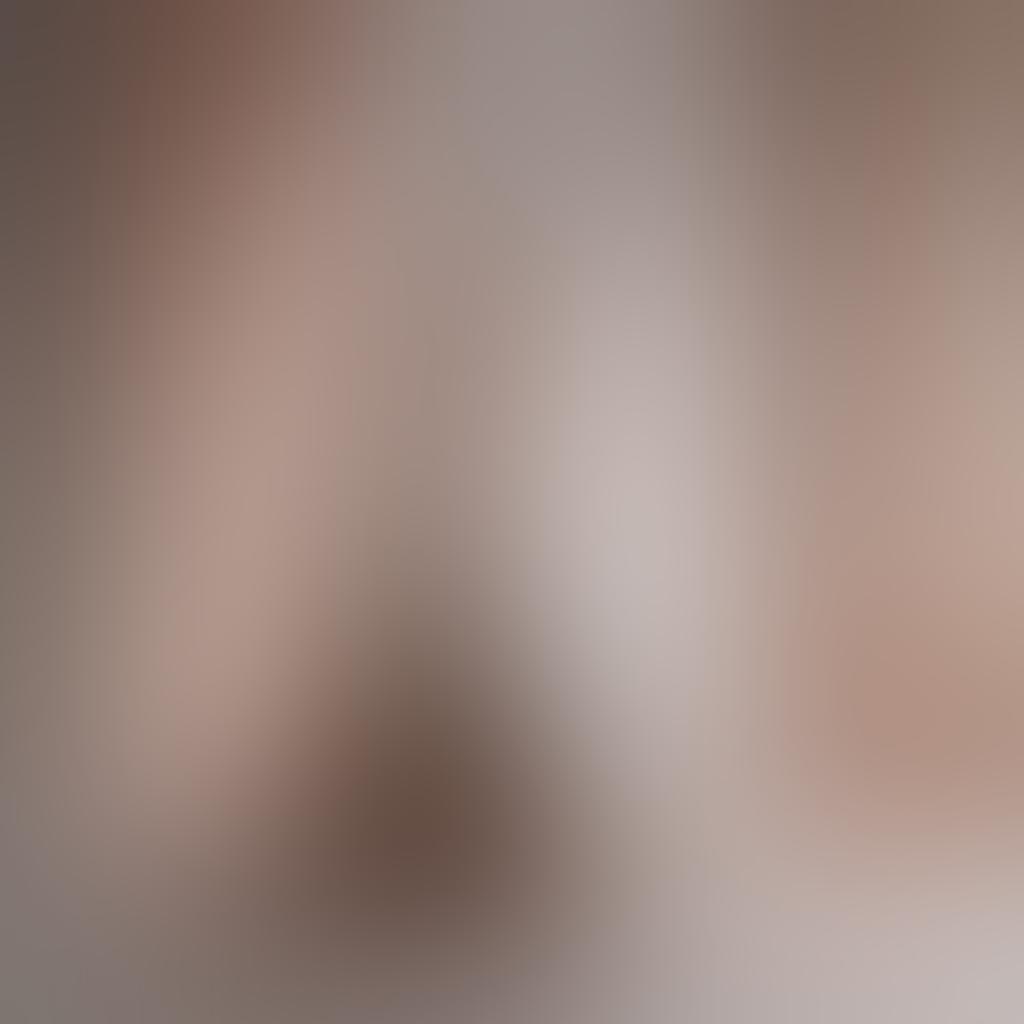 A breathtaking composition of a minimalist studio showcasing a variety of nude sculptures intertwined with draped silk fabrics, soft lighting casting delicate shadows. The backdrop features a soft gradient of pastel colors, evoking a sense of calm and intimacy. Various photography equipment subtly arranged, suggesting the art of capturing sensuality. Inviting and tasteful, highlighting both the grace of the human form and the artistry of photography. super-realistic. soft colors. intimate atmosphere.