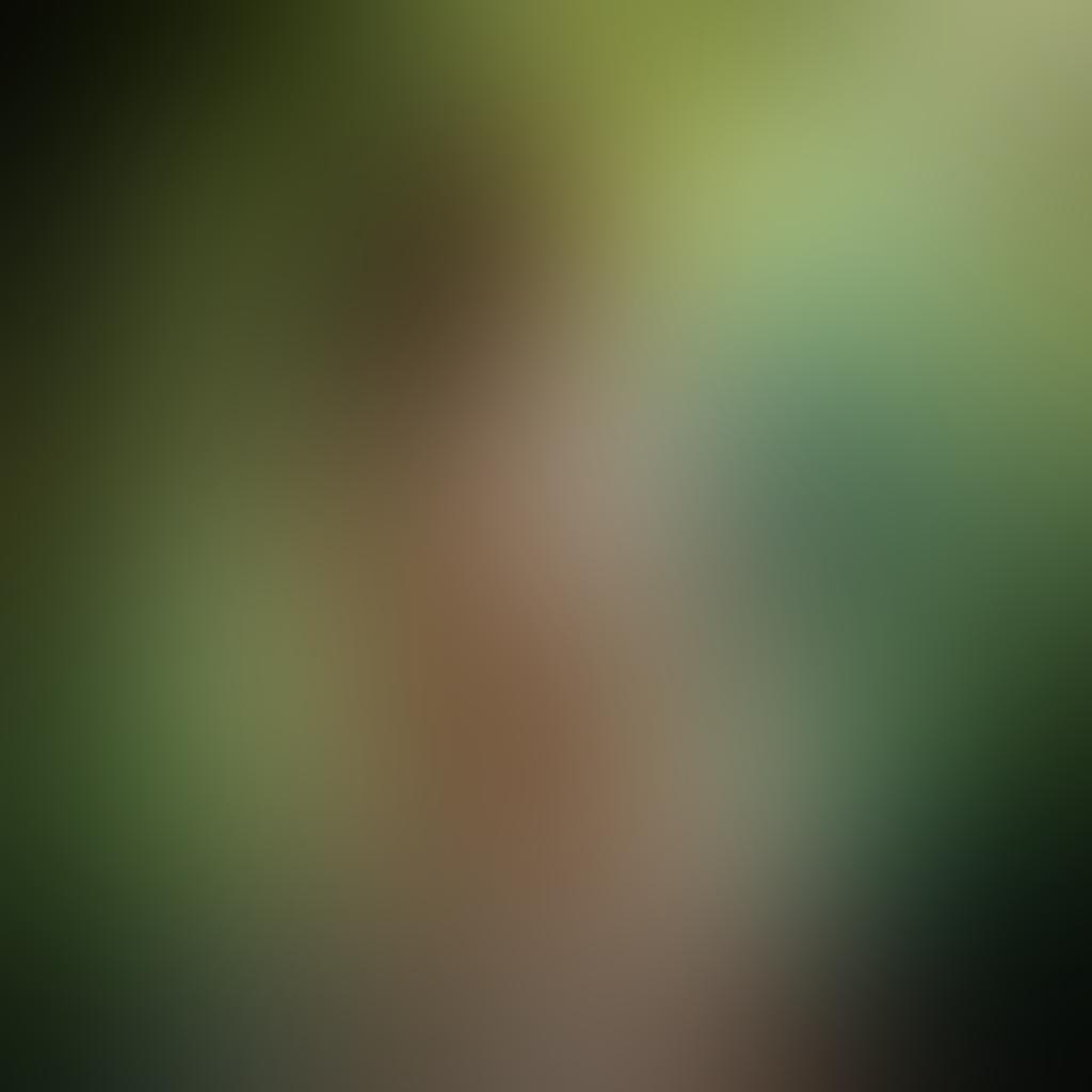 A captivating composition showcasing a soft focus on a silhouette of a nude model artfully posed against a backdrop of nature, with light filtering through leaves, highlighting curves and textures. An ethereal atmosphere with warm tones and gentle shadows to evoke sensuality. Incorporate subtle hints of abstract elements, such as flowing fabrics or water reflections, to enhance depth and intrigue. super-realistic. warm color palette. ethereal lighting.